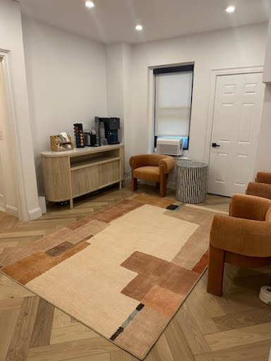 Interior office space featuring a rug and furniture